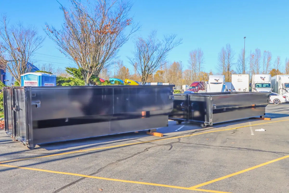 Professional dumpster rental service with roll-off container on residential driveway in Mint Hill